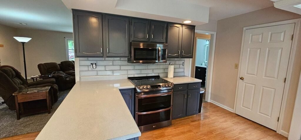 Dark refinished kitchen cabinets with tile backsplash