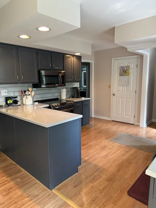 Kitchen with refinished dark island and painted perimeter cabinets