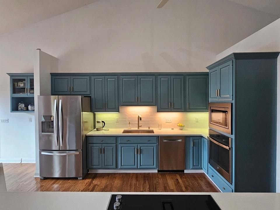 Kitchen cabinets refinished in a deep green finish