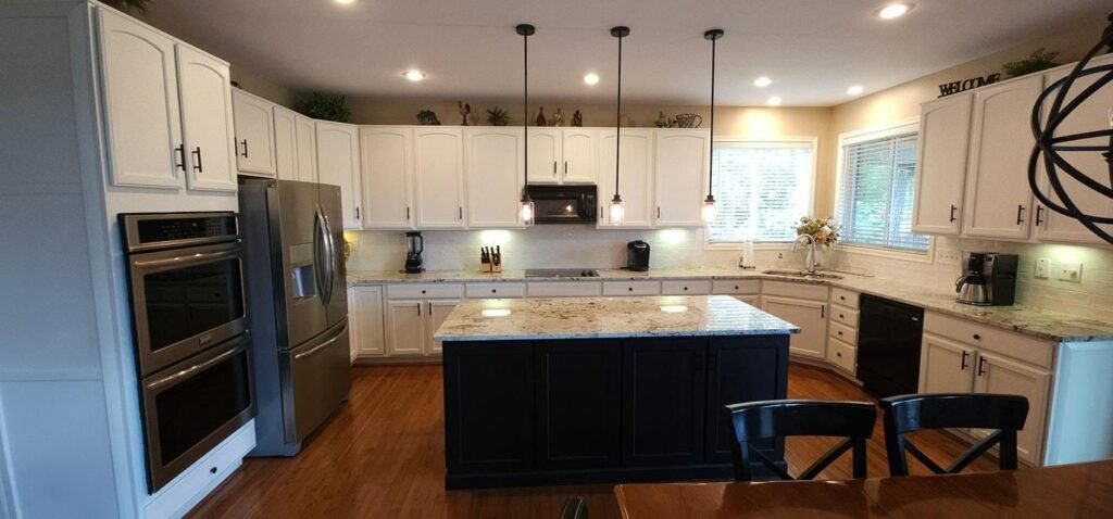 Refinished navy island paired with white perimeter cabinets