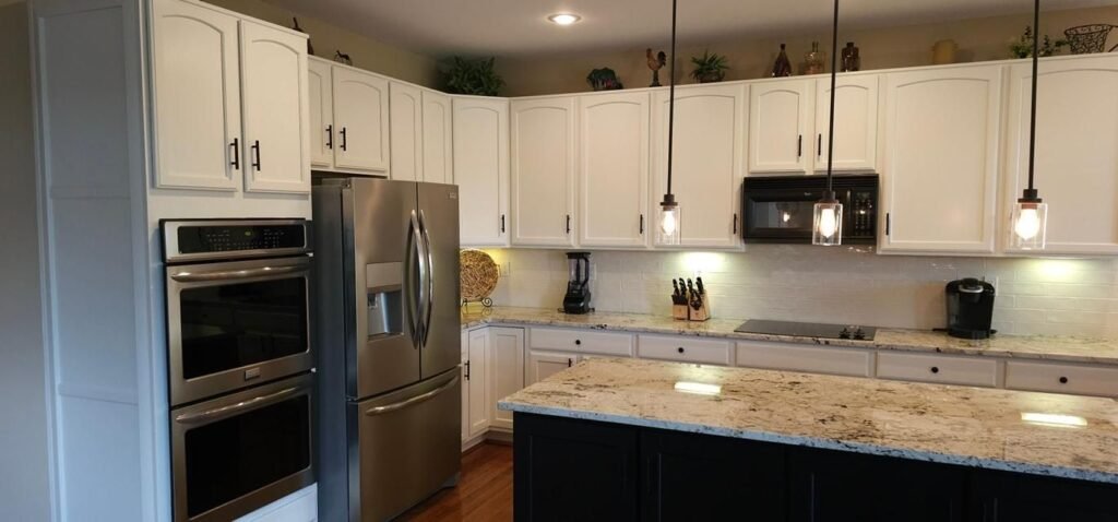 White refinished cabinets with stainless steel appliances