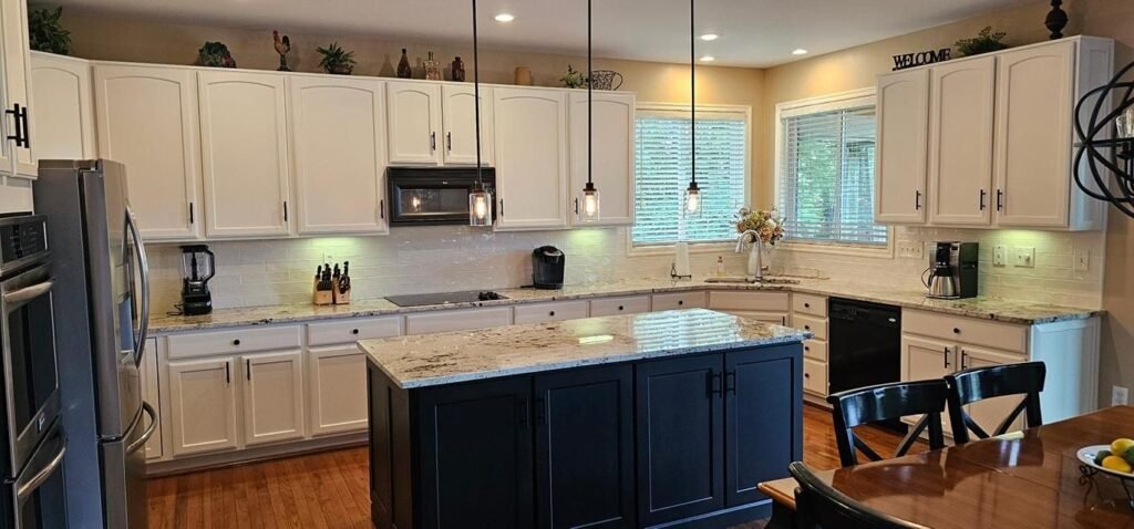 White perimeter cabinets and navy island after cabinet refinishing