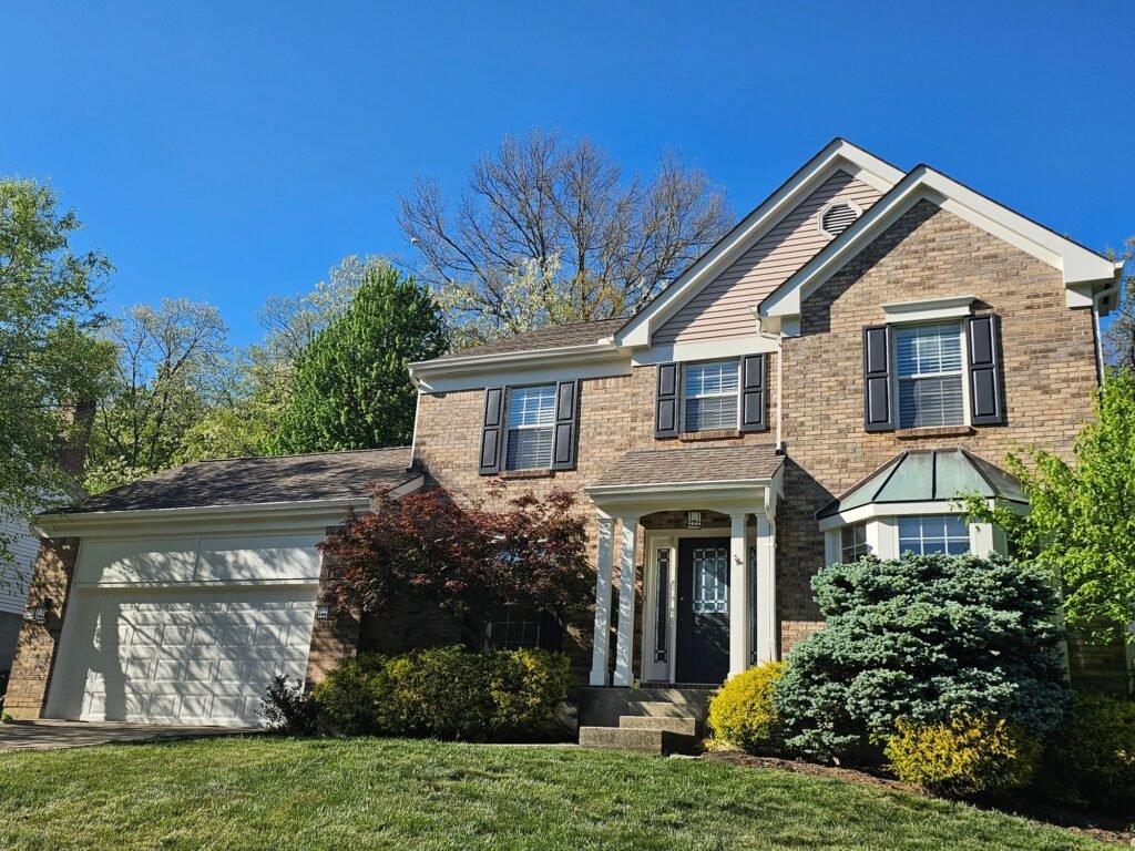 Repainted brick home exterior with fresh trim in the Cincinnati metro area
