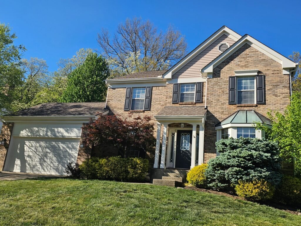 Brick colonial home in Northern Kentucky after exterior painting by Hearts & Hands Restoration