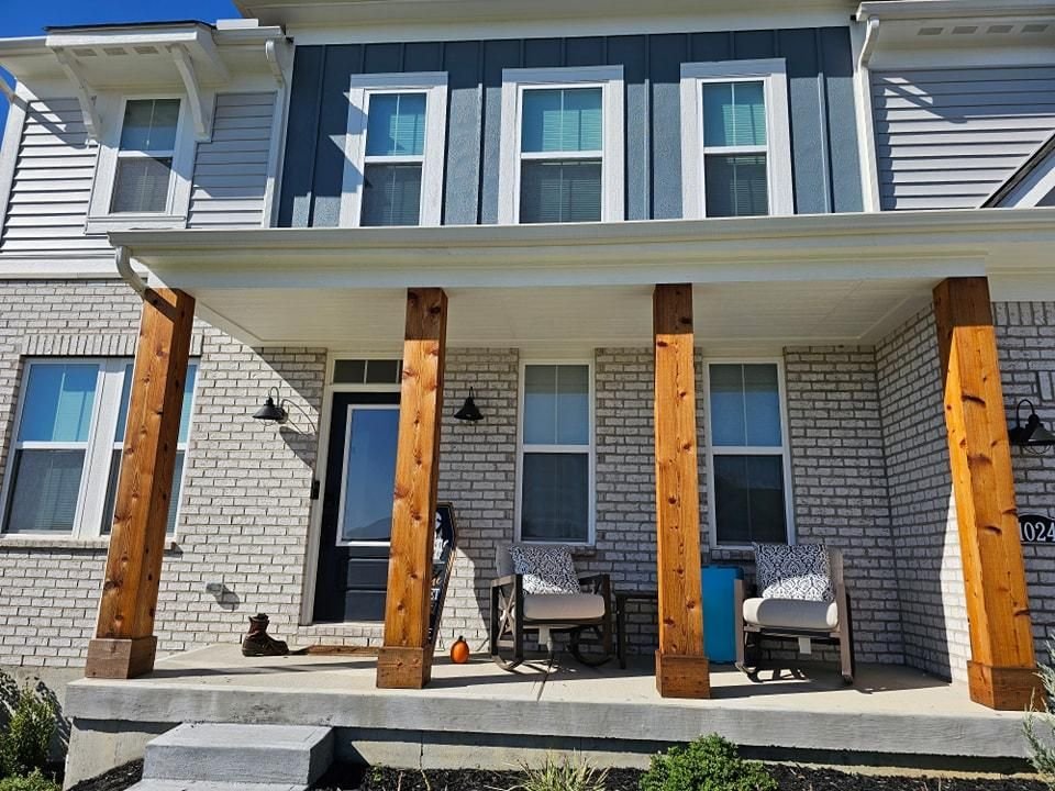 Covered front porch with freshly painted ceiling trim and columns
