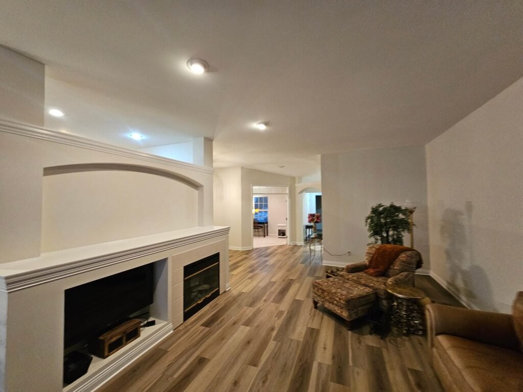 Great room with vaulted ceiling painted by Hearts & Hands Restoration