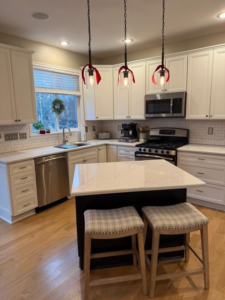 Kitchen with white refinished island and cabinetry