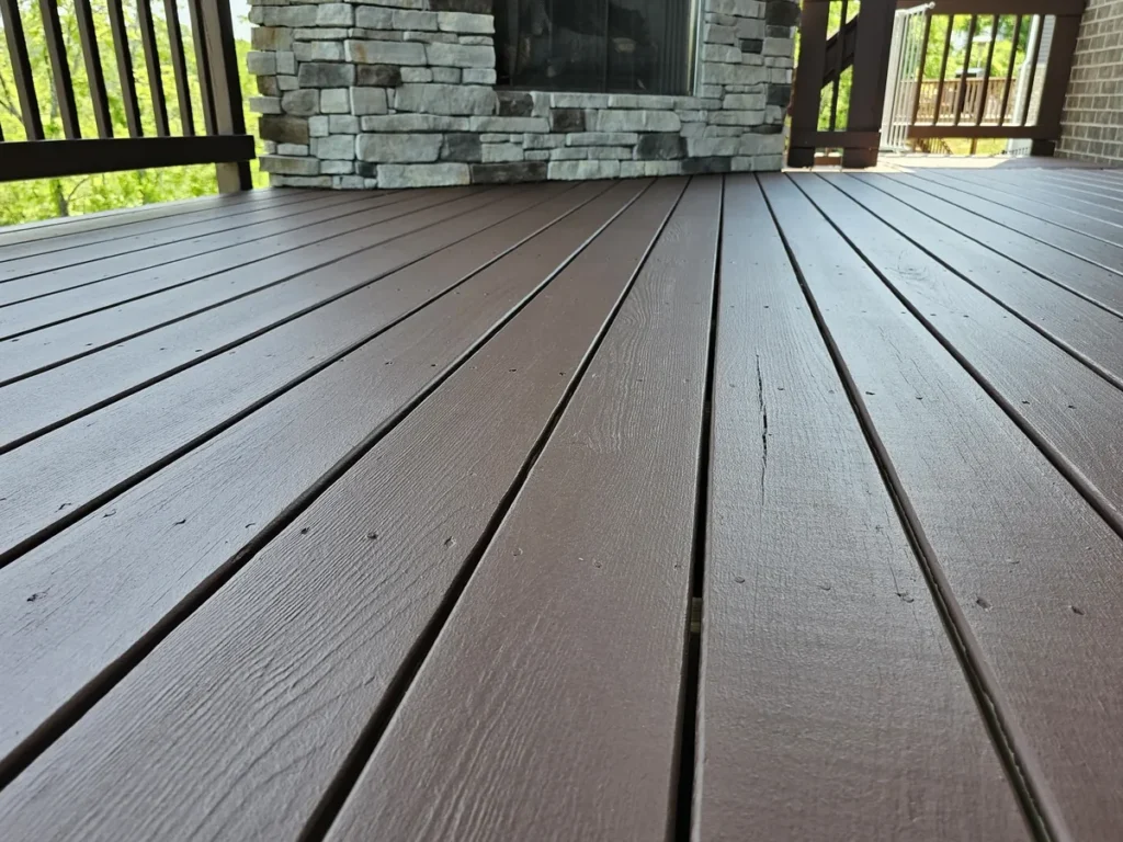 Brown deck boards beside a covered stone fireplace in Alexandria, Kentucky.