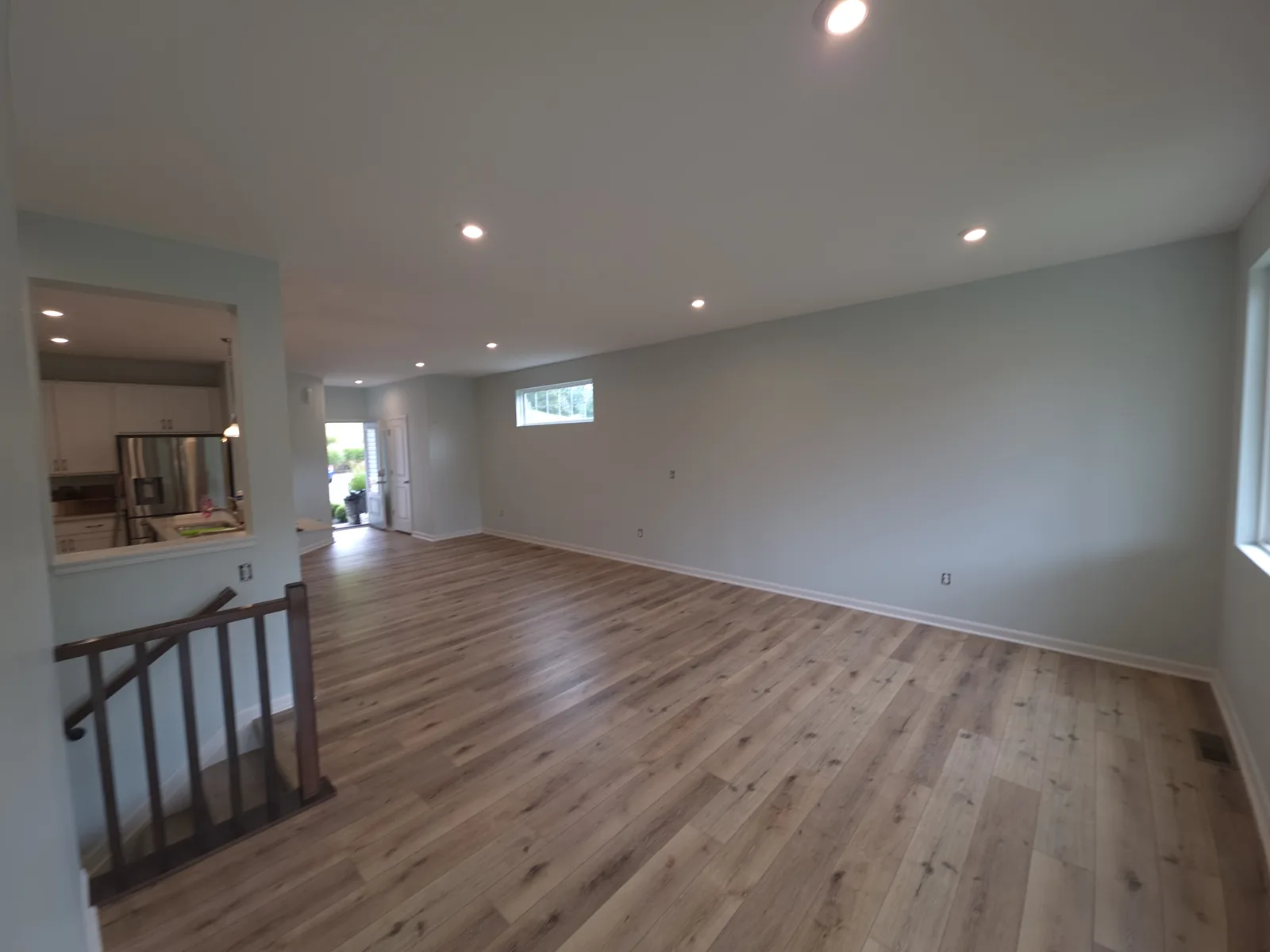 Open interior with pale gray walls, white trim and wood flooring in Alexandria, Kentucky.