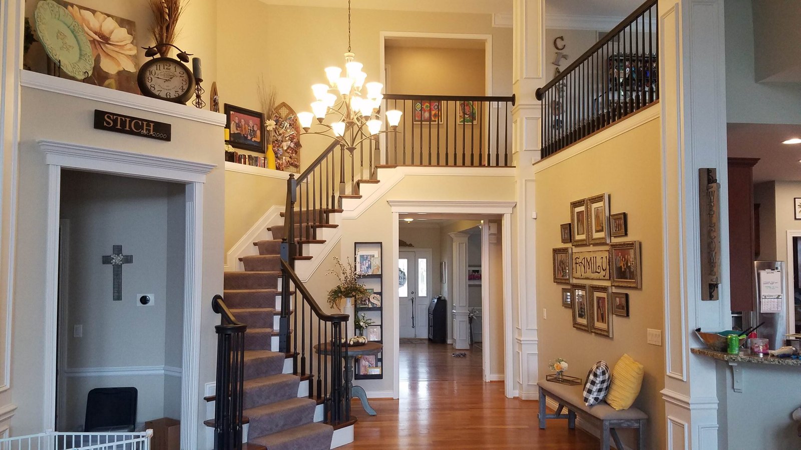 Dark stair railings and balusters with white stair trim in an H&H project in Florence, Kentucky.
