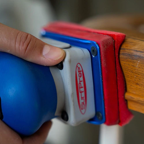 SurfPrep sander smoothing a wood detail.