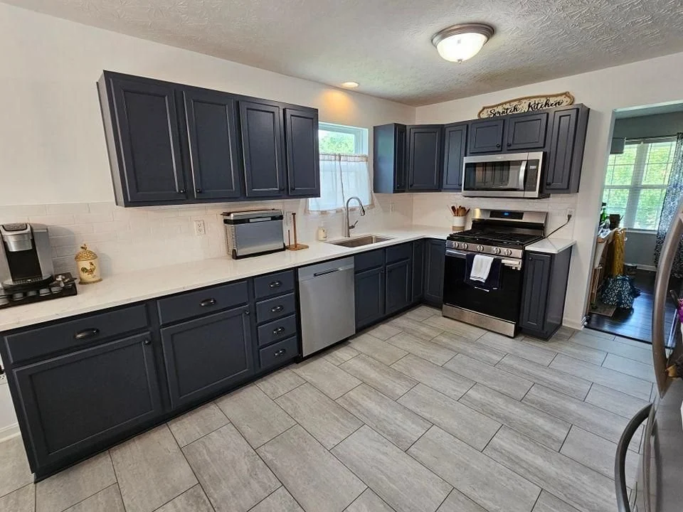 Navy kitchen cabinets with stainless appliances in Independence, Kentucky.