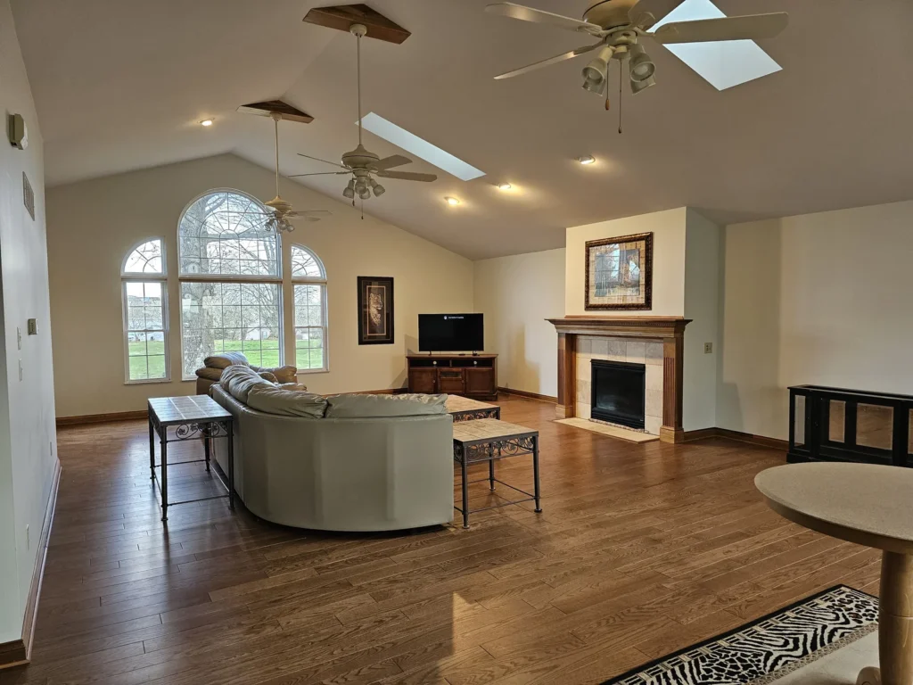 Light vaulted living-room walls and retained wood trim in Independence, Kentucky.